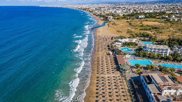 An aerial view of a coastal resort with a beach, multiple swimming pools, and a variety of buildings. - Olive Raki Luxury Pool Villa Crete Garden Oasis (Malevizi)