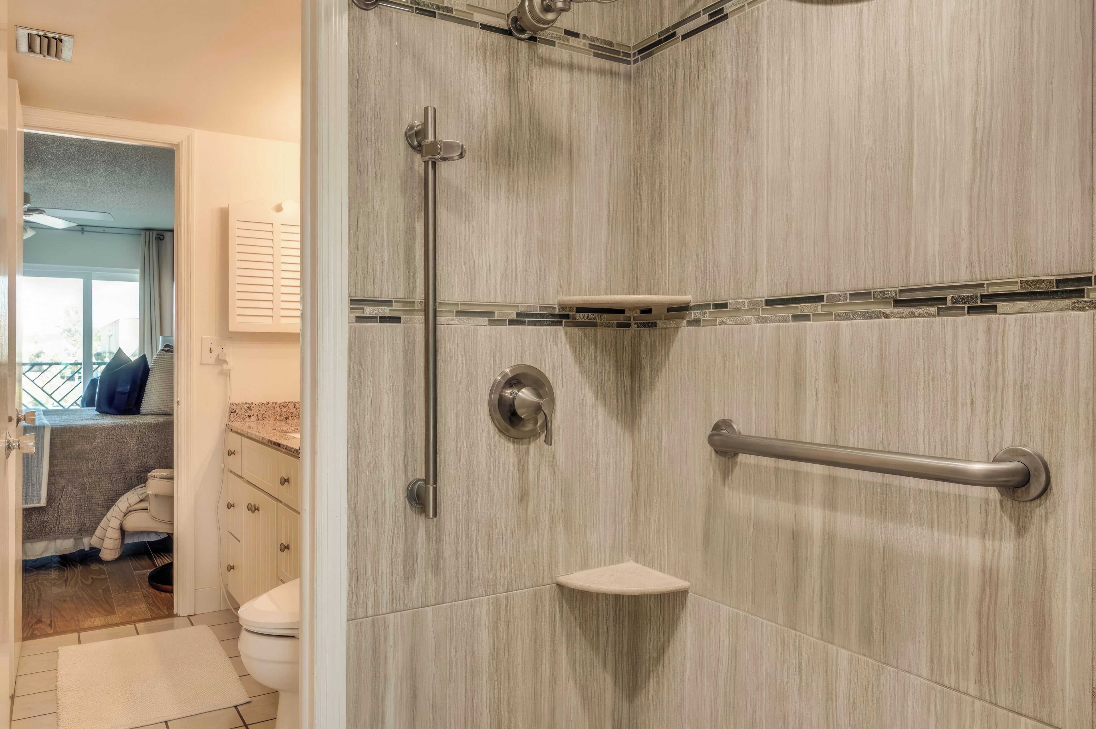 A modern bathroom with a shower, toilet, and sink.