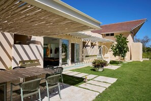 A patio with outdoor furniture, a pergola, and a swimming pool. - Luxury 7BR Villa With Private Pool in Cap Cana (Punta Cana)