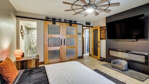 A bedroom with a bed, a ceiling fan, a TV, and a fireplace. - Private Hot Tub + Patio: Condo By Camelback Mtn! (Phoenix)