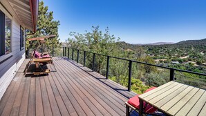 A wooden deck with outdoor furniture, a table, and a view of a hilly landscape. - < 2 Mi to Whiskey Row! Mtn-view Adventure Basecamp (Prescott)