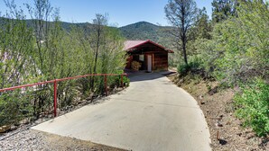 A wooden cabin with a red roof, a concrete pathway leading to it, surrounded by trees and hills. - < 2 Mi to Whiskey Row! Mtn-view Adventure Basecamp (Prescott)