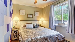 A bedroom with a bed, two bedside lamps, a ceiling fan, a window with curtains, and wall decorations. - < 2 Mi to Whiskey Row! Mtn-view Adventure Basecamp (Prescott)