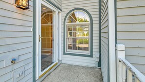 A house entrance with a door, a window, and a light fixture. - 4 Mi to Saratoga Course! Resort-style Condo (Saratoga Springs)