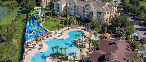 A resort with a large swimming pool, a water park, and multiple hotel buildings.