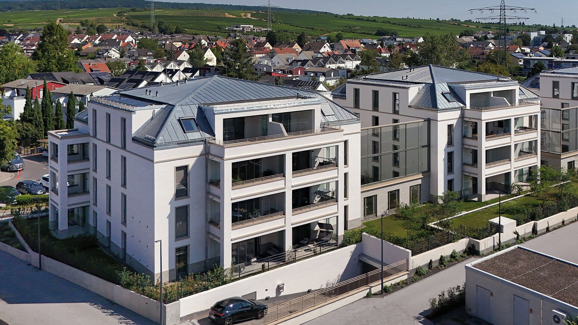 A modern multi-story residential building with balconies and a flat roof.