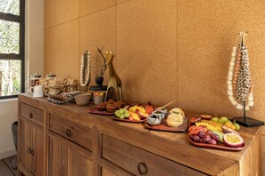 A breakfast buffet with various fruits, pastries, and beverages. - Tsholo Safari Lodge (Pilanesberg National Park)