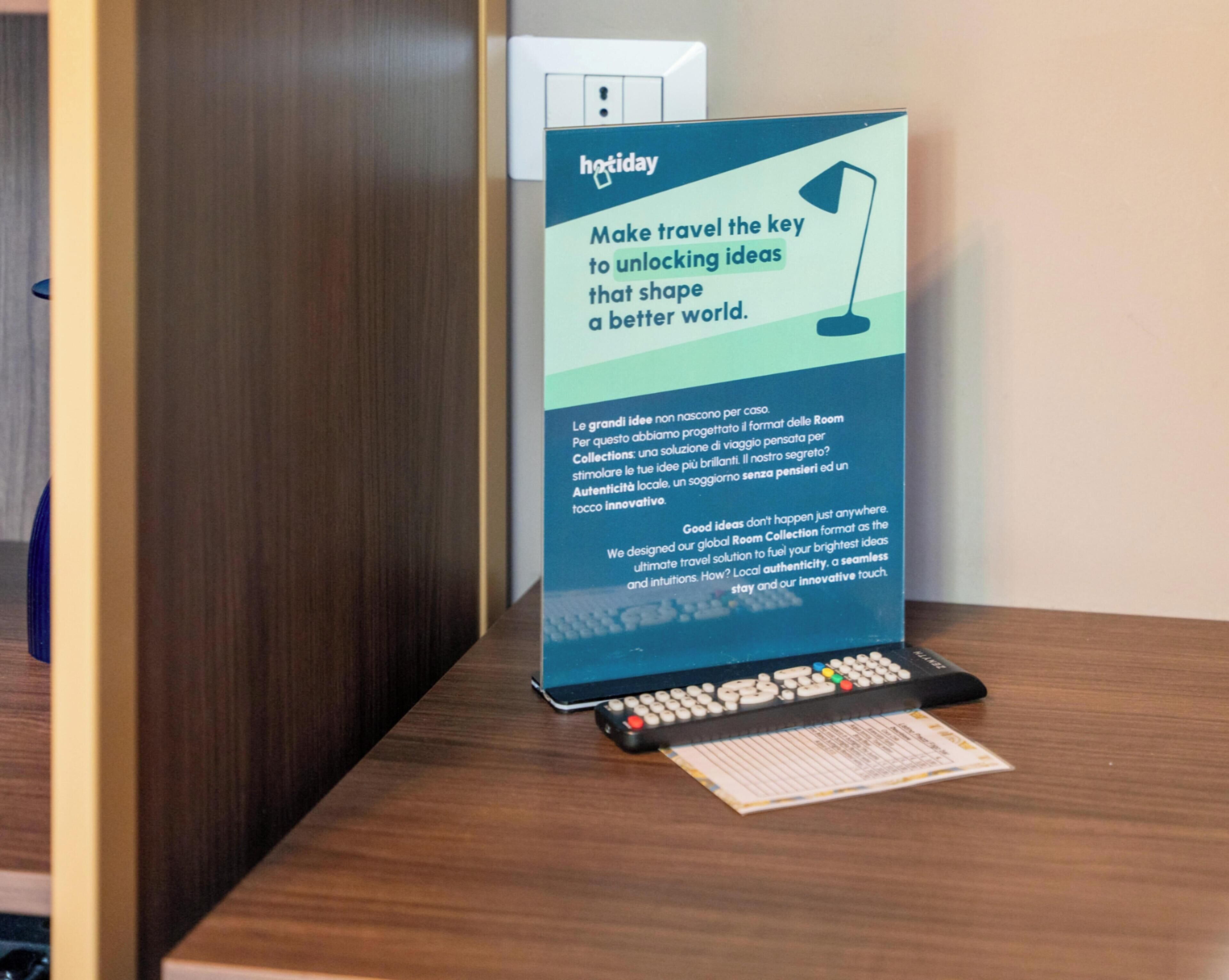 A promotional sign for a hotel with a message about travel and ideas.