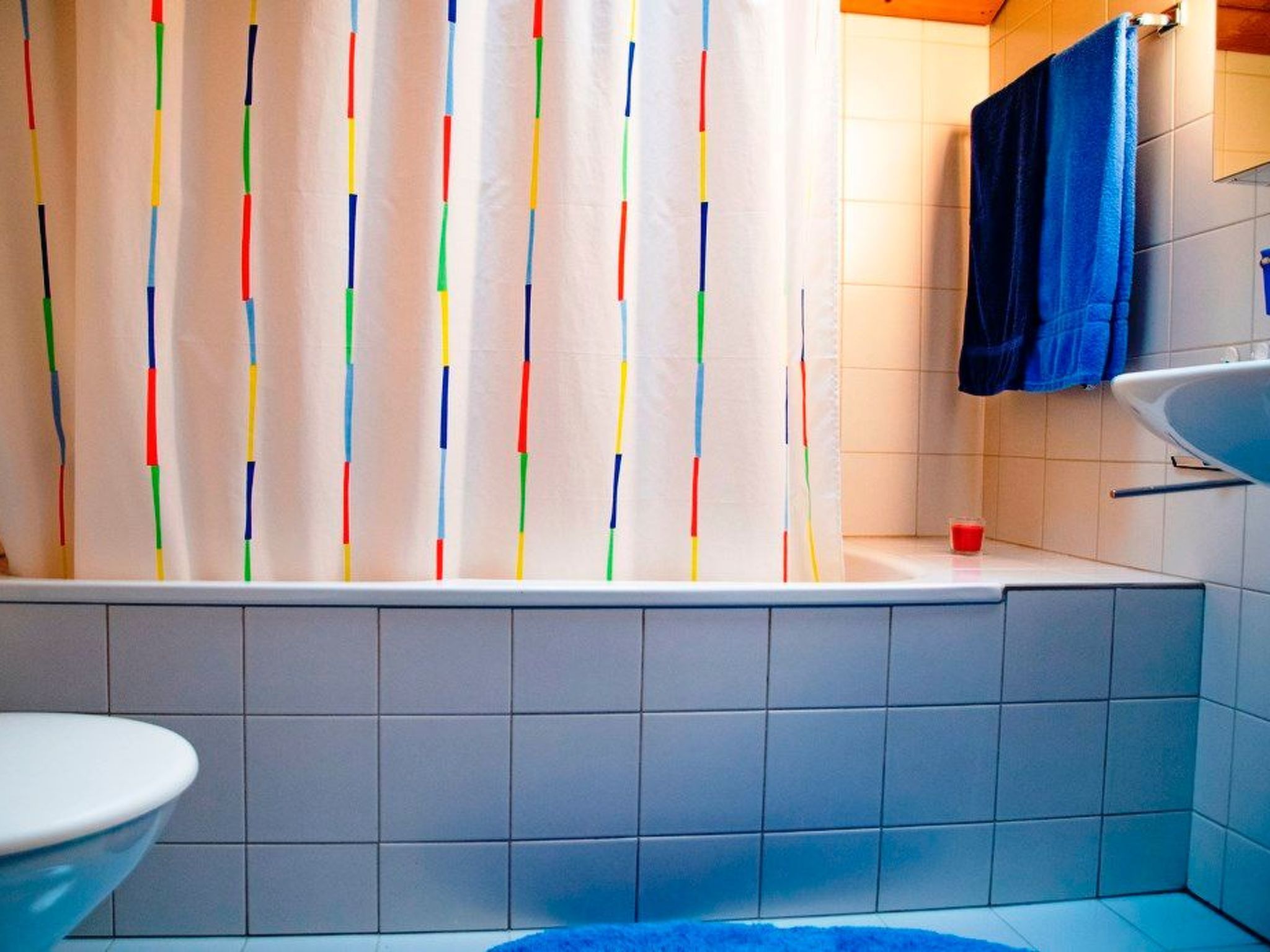 A bathroom with a bathtub, a toilet, and a sink.