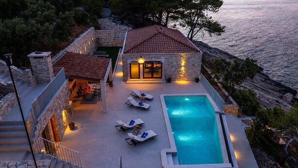 A stone villa with a swimming pool, outdoor seating, and a view of the sea. - Amazing home in Zukova (Zukova)