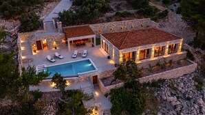 A two-story stone house with a swimming pool, outdoor seating, and a stone pathway. - Amazing home in Zukova (Zukova)