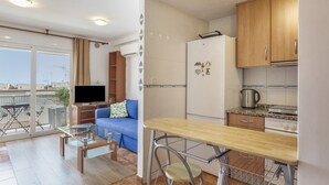 A compact living space with a kitchenette, a dining area, and a seating area with a sofa and a TV. - Berni's House Palafolls Apartment with Sea Views, Private Terrace & Air Conditioning (Palafolls)