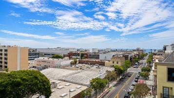 A cityscape with a clear sky, buildings, and a street with vehicles.