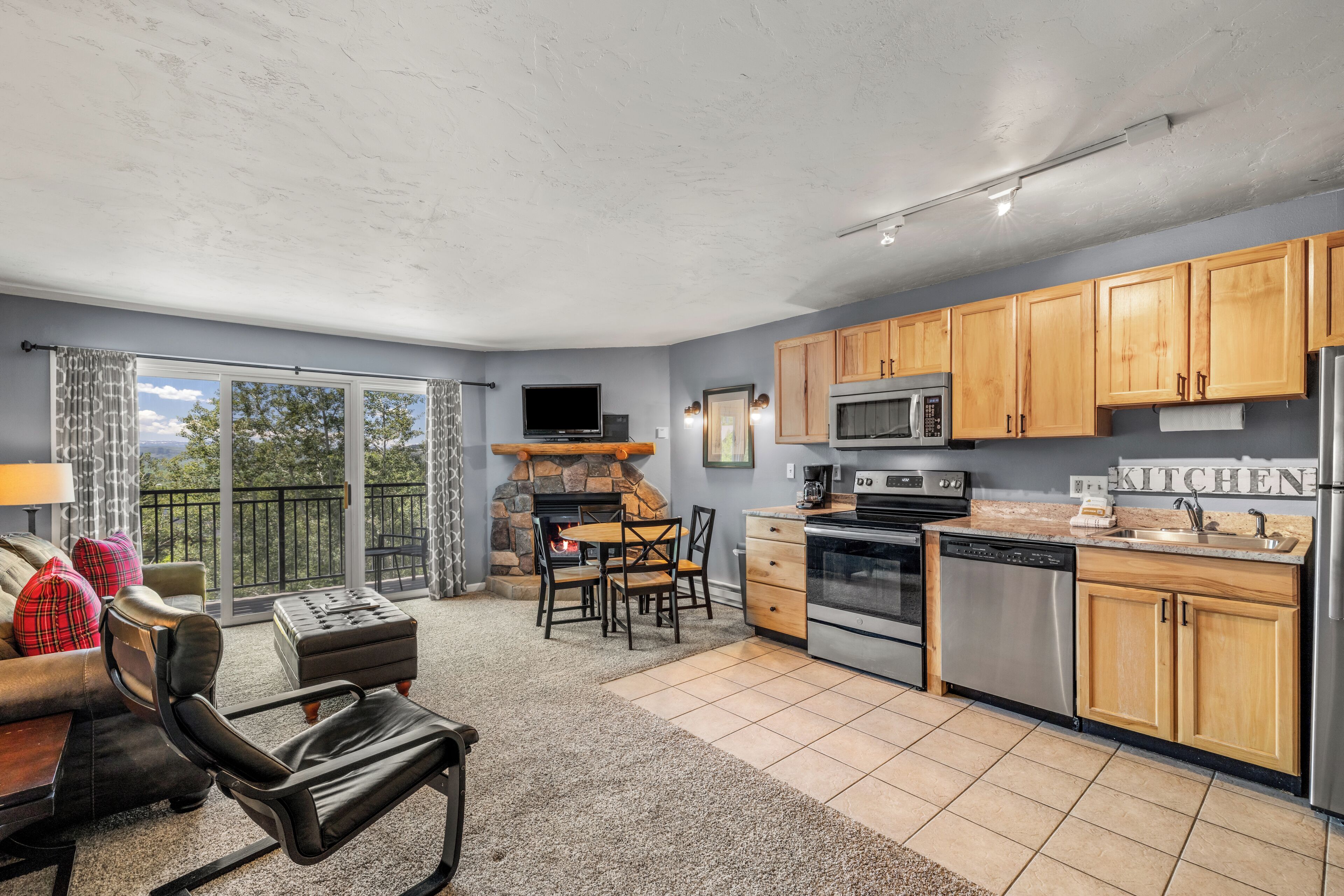 A modern kitchen with wooden cabinets, a built-in oven, and a dishwasher.