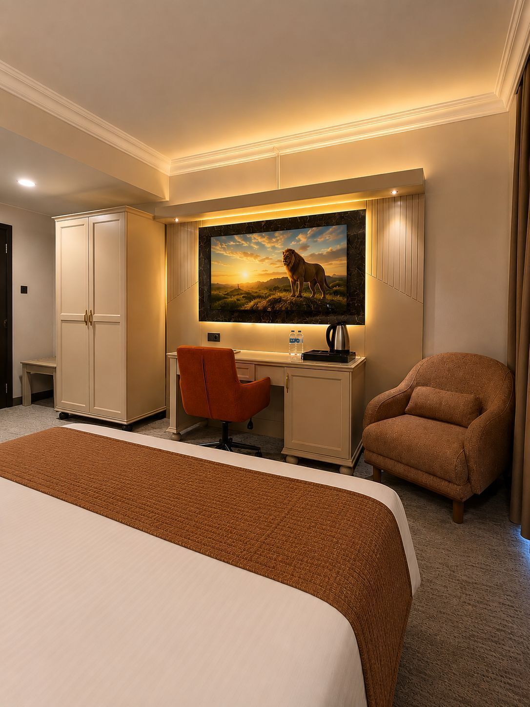A hotel room with a bed, a desk, a chair, a wardrobe, and a painting of a lion.