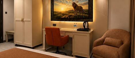 A hotel room with a bed, a desk, a chair, a wardrobe, and a painting of a lion.
