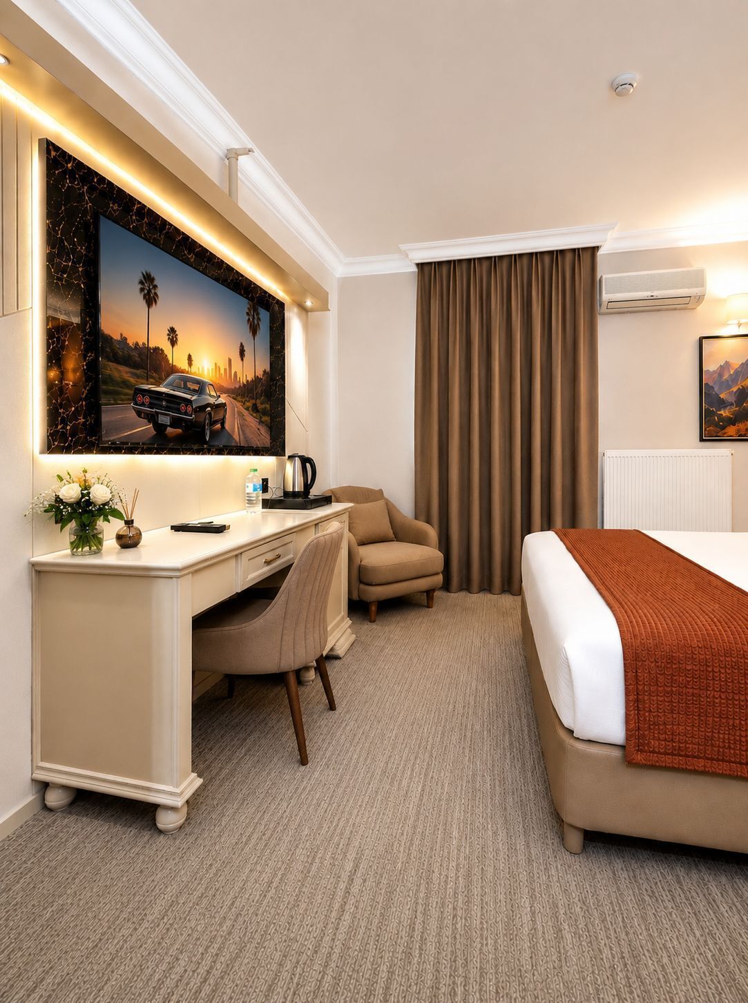 A hotel room with a bed, a desk, a chair, a coffee maker, and a painting on the wall.