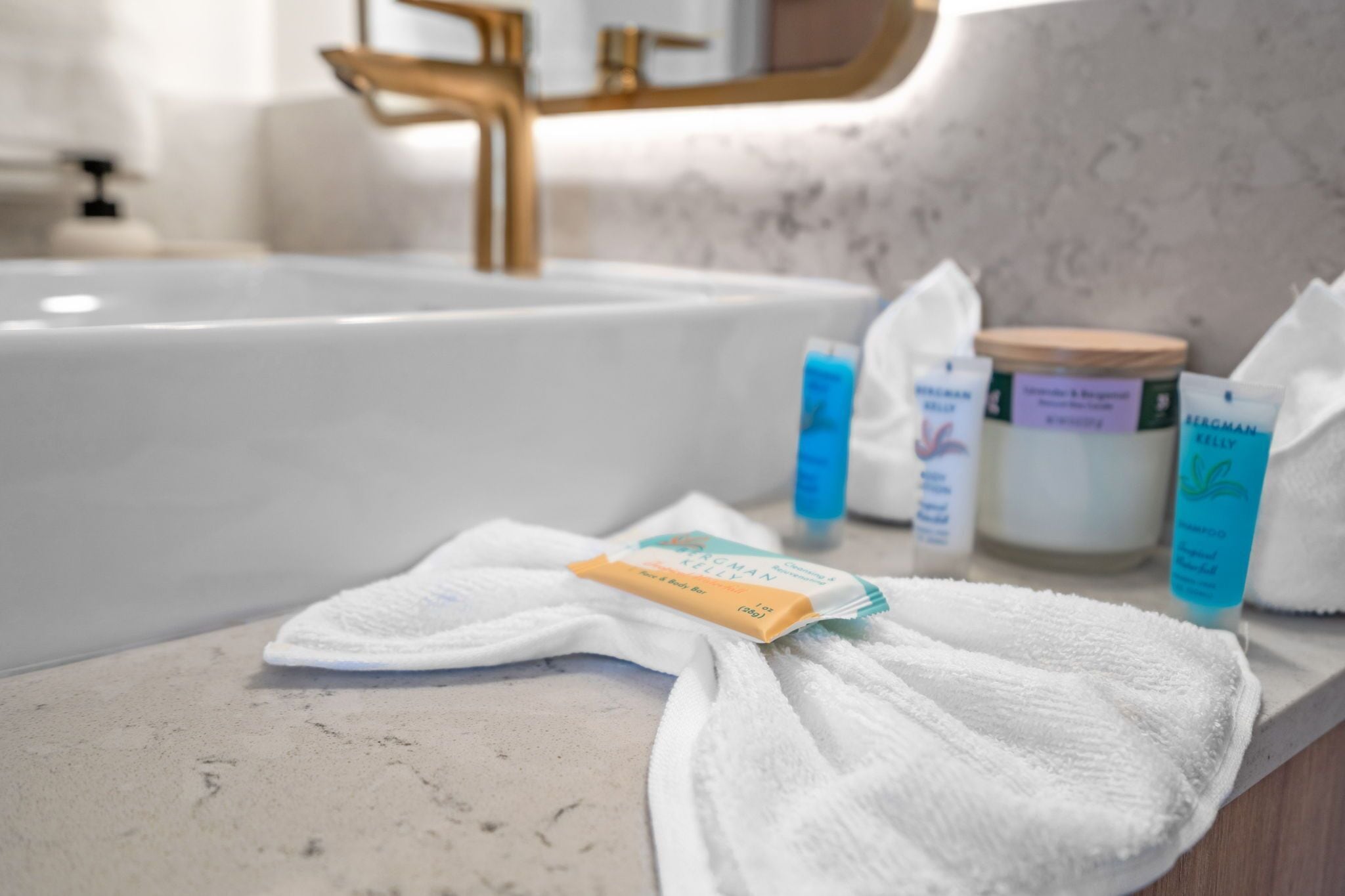 A bathroom with a bathtub, a towel, and toiletries on the counter.