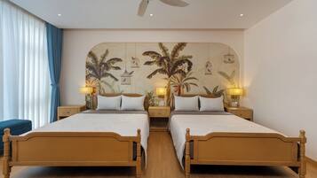 A double bed room with a ceiling fan, two bedside tables with lamps, and a large wall mural with birds and foliage.