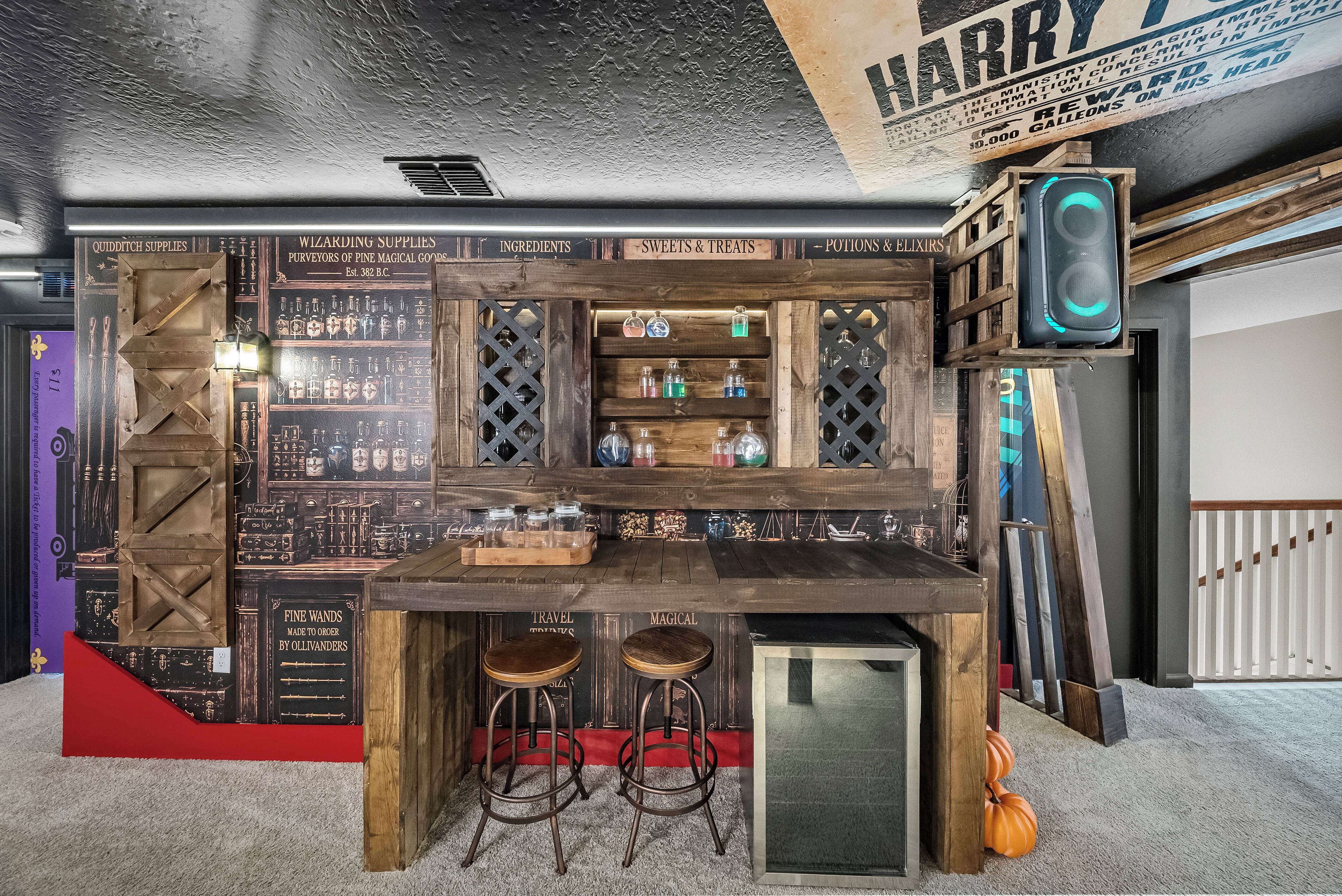 A themed bar area with wooden shelves, stools, and a vintage sign.