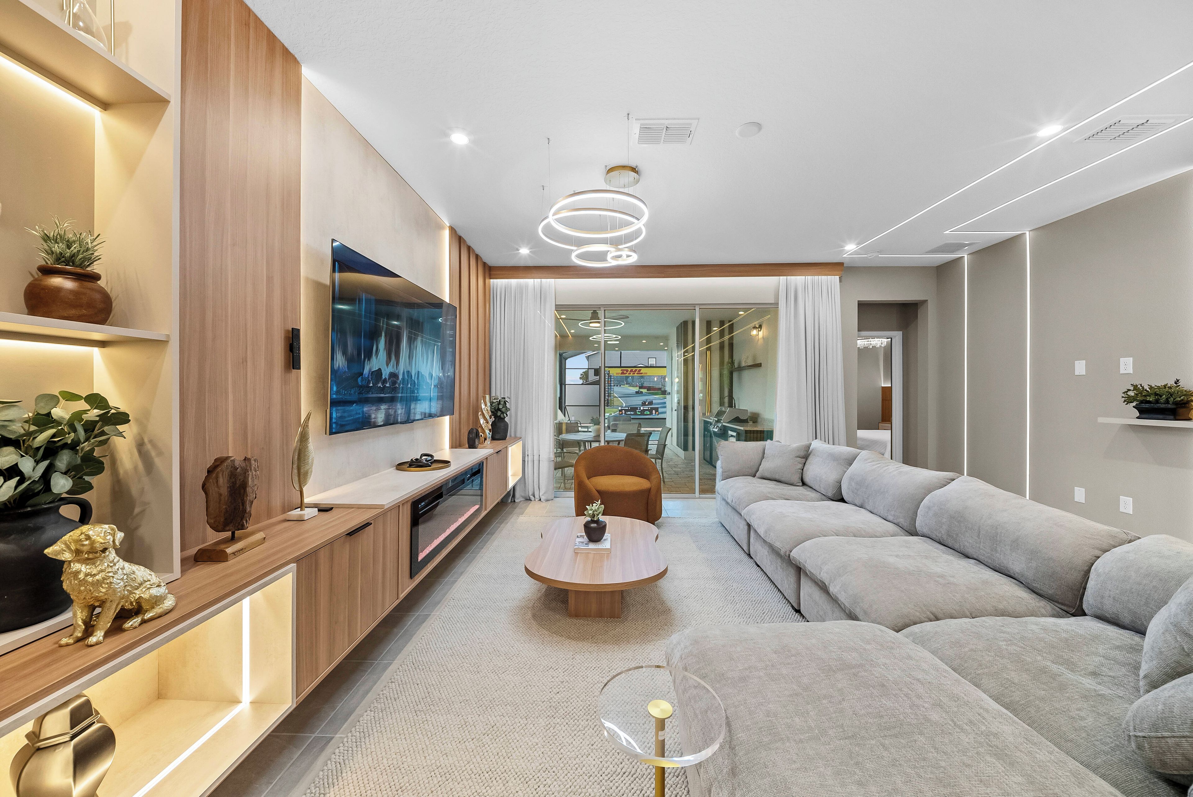 A modern living room with a sofa, a coffee table, and a TV.