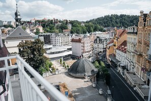 A cityscape with historic buildings, a prominent dome structure, and a modern building with a glass facade.