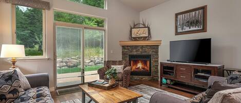 A living room with a fireplace, a television, and a sofa.