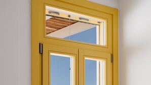 A yellow-framed door with a view of the beach and ocean.