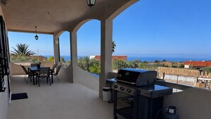 A covered patio with a grill, dining table, and chairs, overlooking a scenic view. - 'Dimora Del Principe' with Sea View, Wi-Fi and Air Conditioning (Principe)