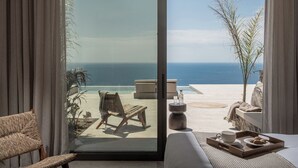 A room with a glass door leading to a balcony with a view of the ocean. - Villa Aeterna - Exclusive 7-Bedroom Villa. Spectacular Sea Views & Total Privacy (Viannos)