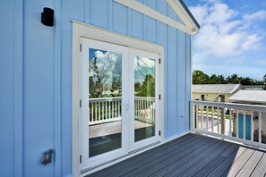 A blue building with a white door and a wooden deck. - Pool Home Pet Friendly  Fenced Yard  Near Beach (Fort Myers)