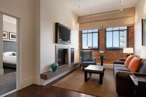 Una sala de estar moderna con chimenea, televisor, sofá y mesa de centro.