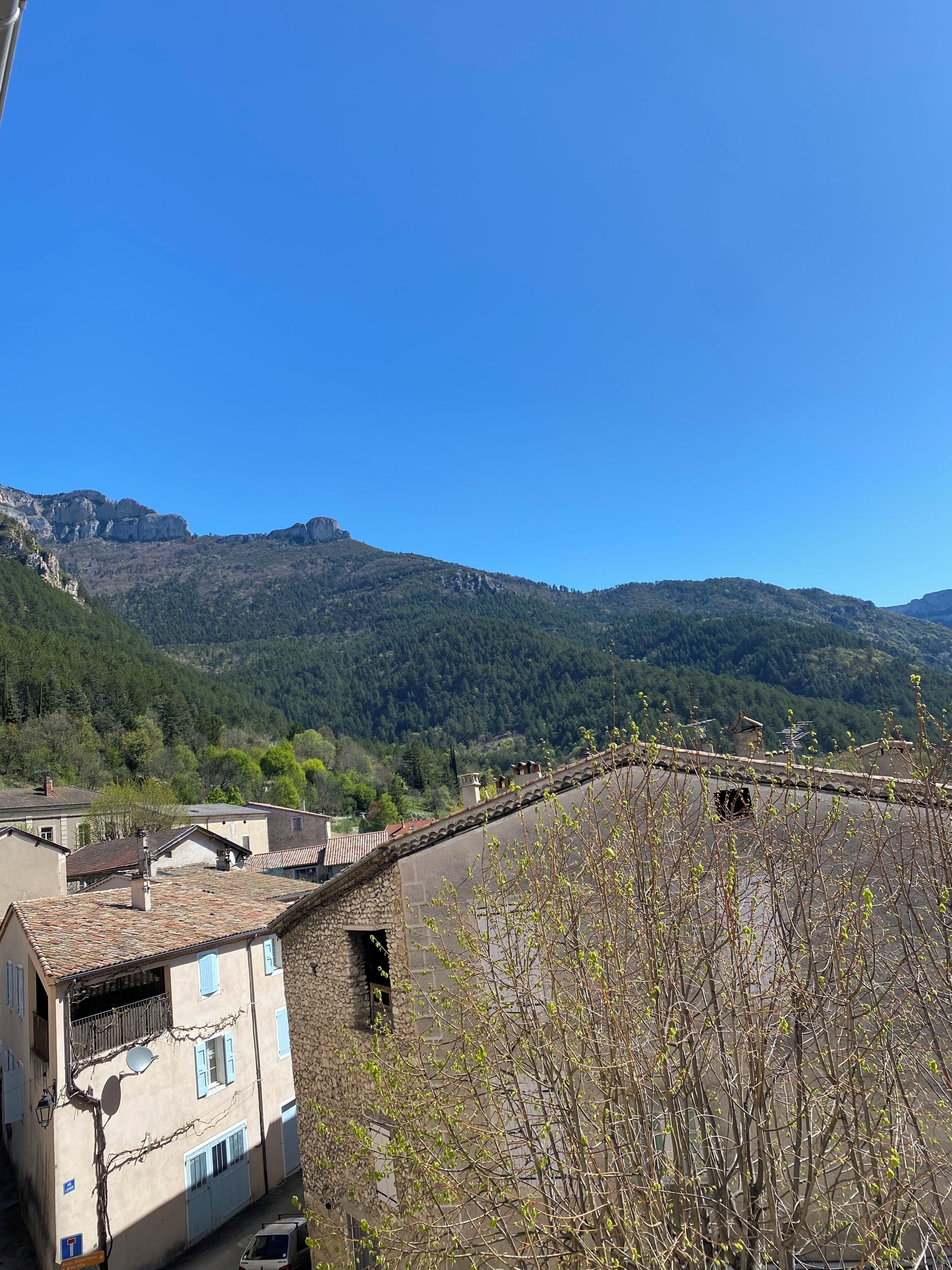 A mountainous landscape with buildings in the foreground.