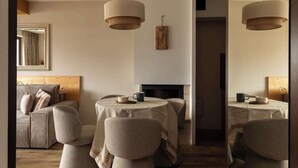 A cozy room with a sofa, two chairs, a table, and a fireplace. - Butorowy Residence | Sauna & Gym | Mountain View (Kościelisko)