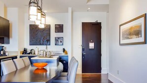 A modern kitchen with a dining area, featuring a large table, chairs, and a hanging light fixture. - Wonderful 2-bedroom apartment with AC in San Francisco (San Francisco)