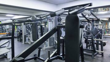 A gym with various exercise equipment, including weight machines and free weights.