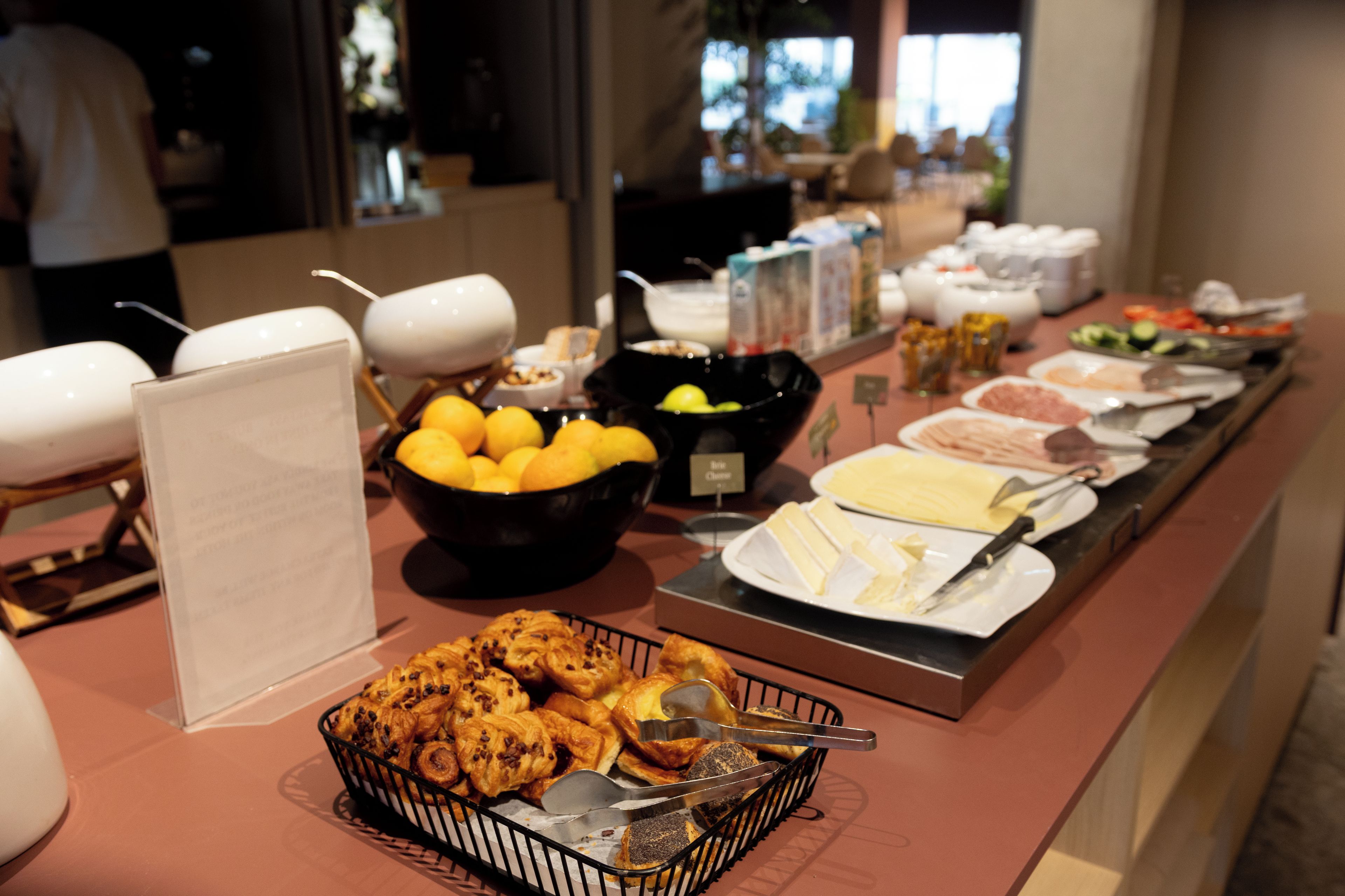 A buffet with various food items and utensils.