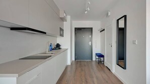 A modern kitchen with a countertop, cabinets, and a stove.