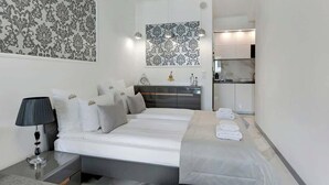 A hotel room with a bed, bedside table, lamp, and a wall with a patterned design. - Granaria B23 | Perfect Location | Old Town (Gdańsk)