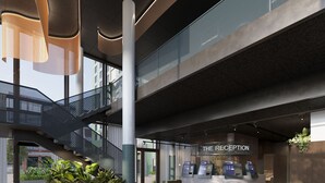 A modern reception area with a staircase, seating, and reception counters. - Citybox Tromsø (Tromsø)