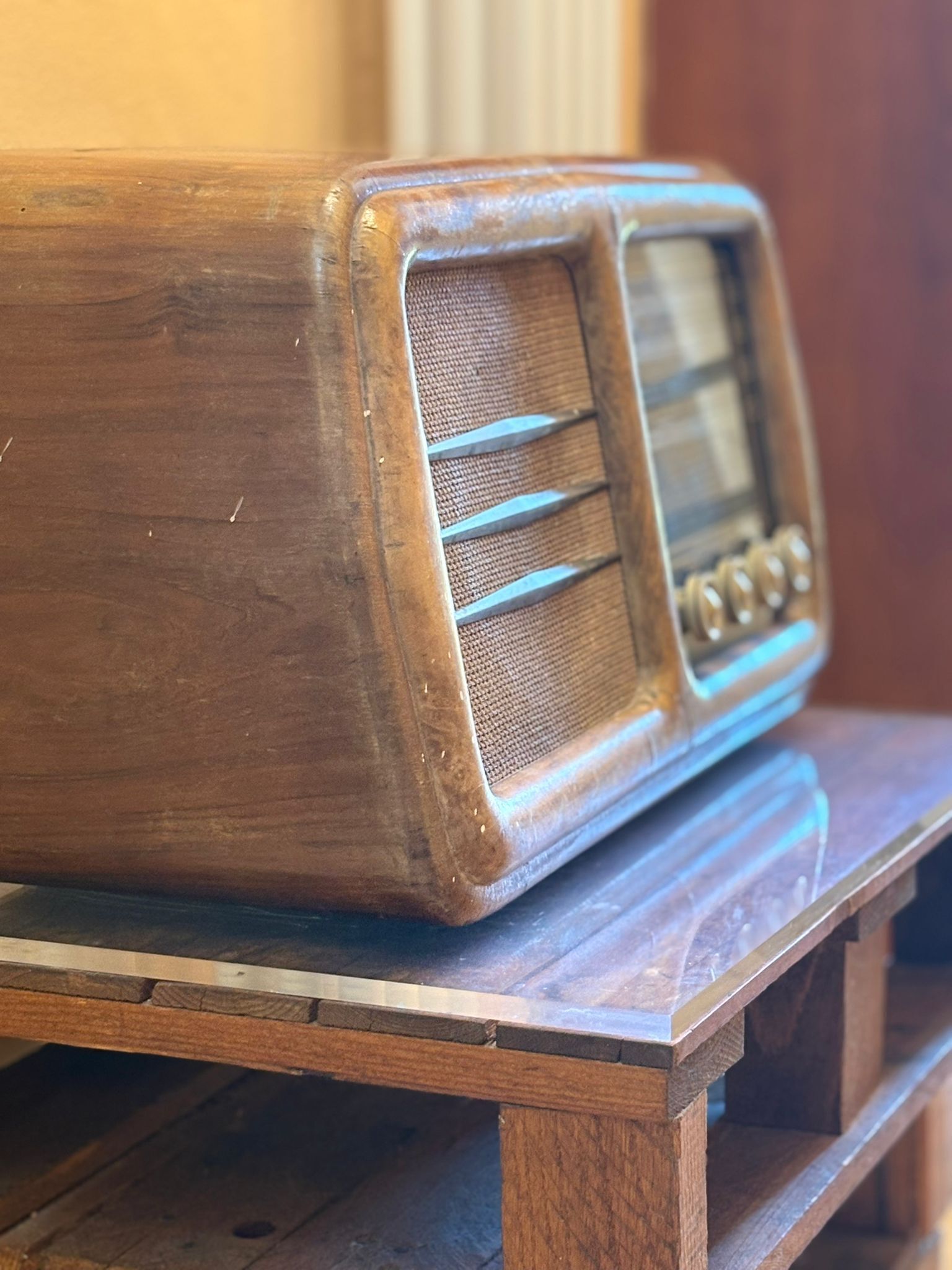 En trådløs radio i træ står på et træbord.