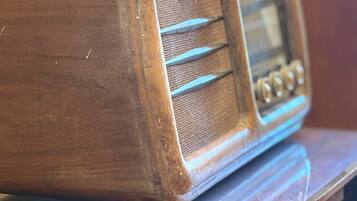 A wooden radio on a wooden table.