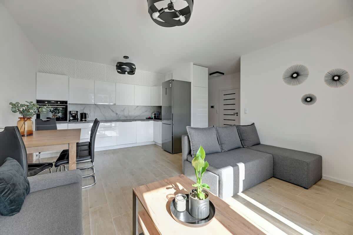 A modern living space with a kitchen, dining area, and seating area.