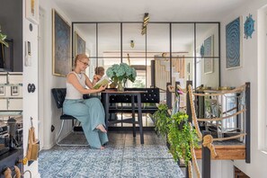 A room with a dining table, chairs, a bookshelf, and a large window. - House 200 metres to the Sopot beach | Beach & Park (Sopot)