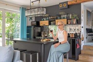 A modern kitchen with a central island, built-in appliances, and a view of greenery outside. - House 200 metres to the Sopot beach | Beach & Park (Sopot)