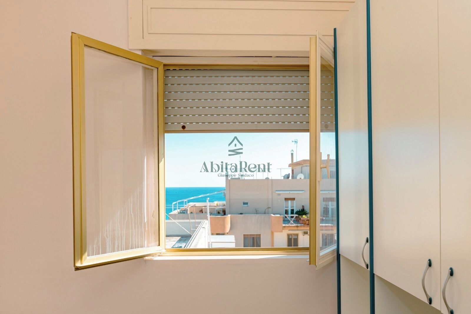 A window with a view of buildings and a logo for Abitalent.