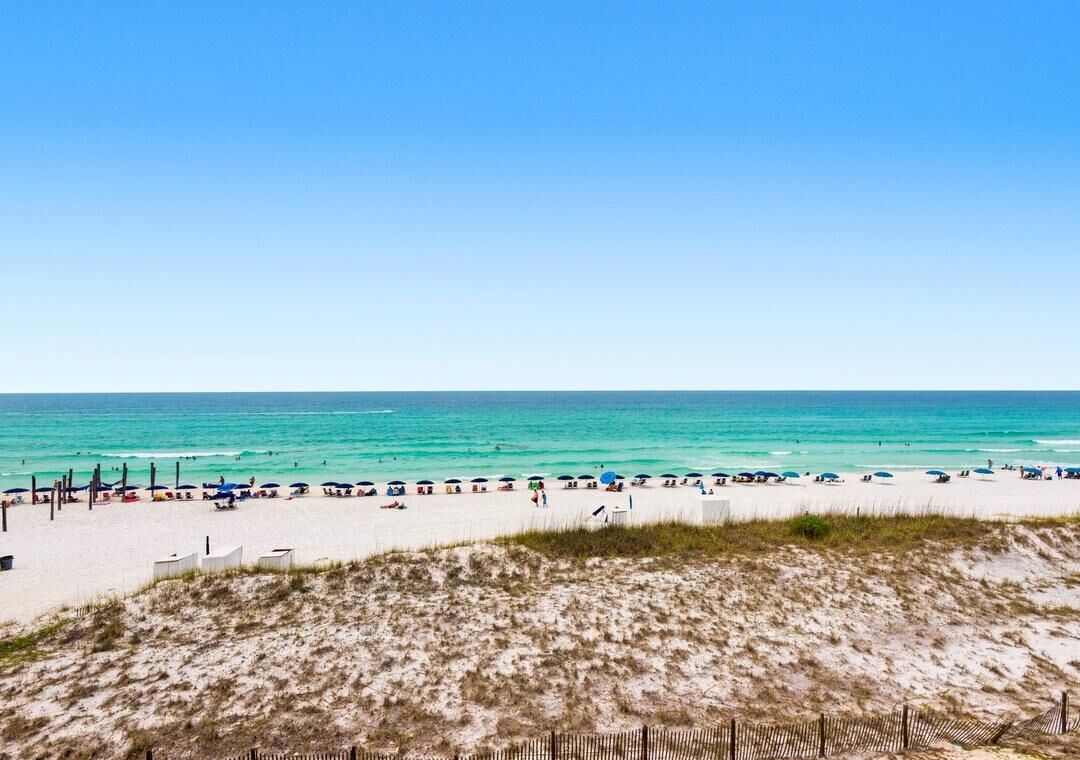 Hiekkaranta, jossa on aita ja meri.