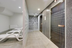 A hallway with a tiled floor, a white radiator, and a door with a metal handle. - Waterlane SPA E7 | Spa, Pool & Gym | Riverside (Gdańsk)