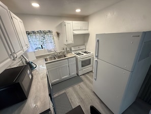 Coffee/tea maker, fridge, microwave, oven