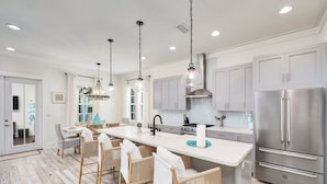 A modern kitchen with a large island, stainless steel appliances, and pendant lighting. - Crisp Ocean Breeze | Private Pool | Walk to Beach | Golf Cart(LSV) (Santa Rosa Beach)